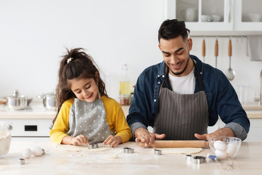positive-arab-family-dad-and-daughter-baking-cooking