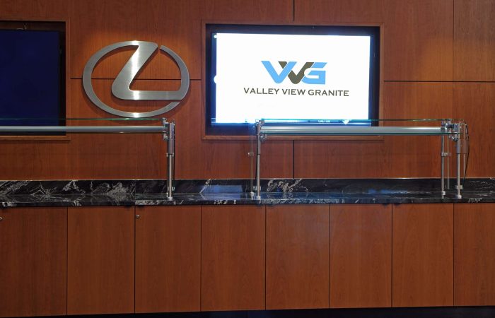 Black granite counter with VVG logo and wood cabinetry
